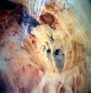 Wind eroded volcanoes and rock outcrops, Sahar Desert, Libya.